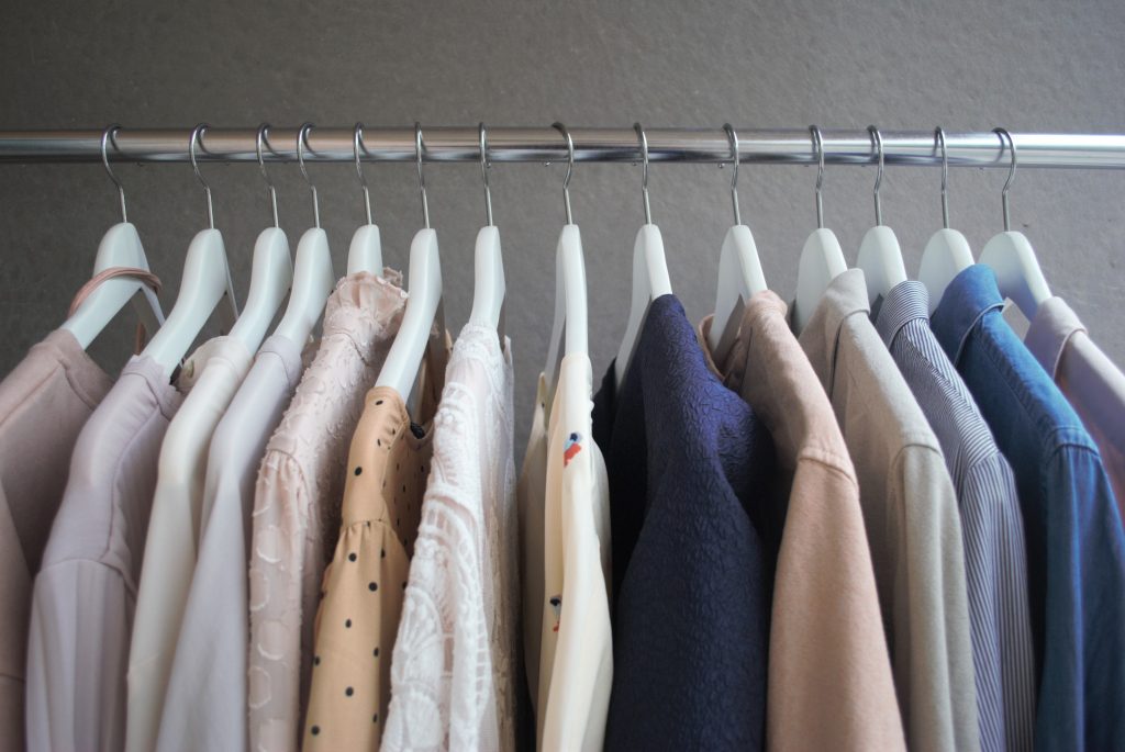 Kläder på galge hängandes på klädställning.